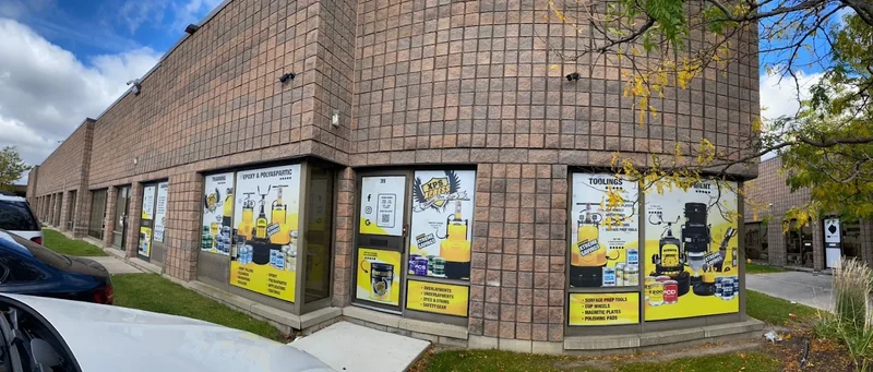 The building at 90 Nolan Ct seen from the parking lot, with the yellow XPS Xpress windows at the corner